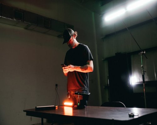 Person adjusting the brightness settings on a smartphone in a dim room
