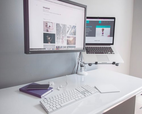 Ergonomic desk setup with a monitor placed at an arm's length distance from the chair